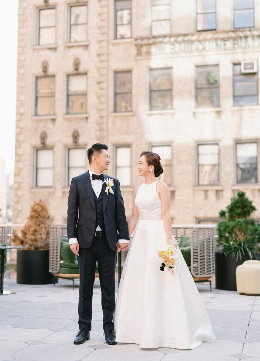 Best Places for a Minimalist Wedding: A bride and groom on a patio at The Ritz-Carlton New York, NoMad.