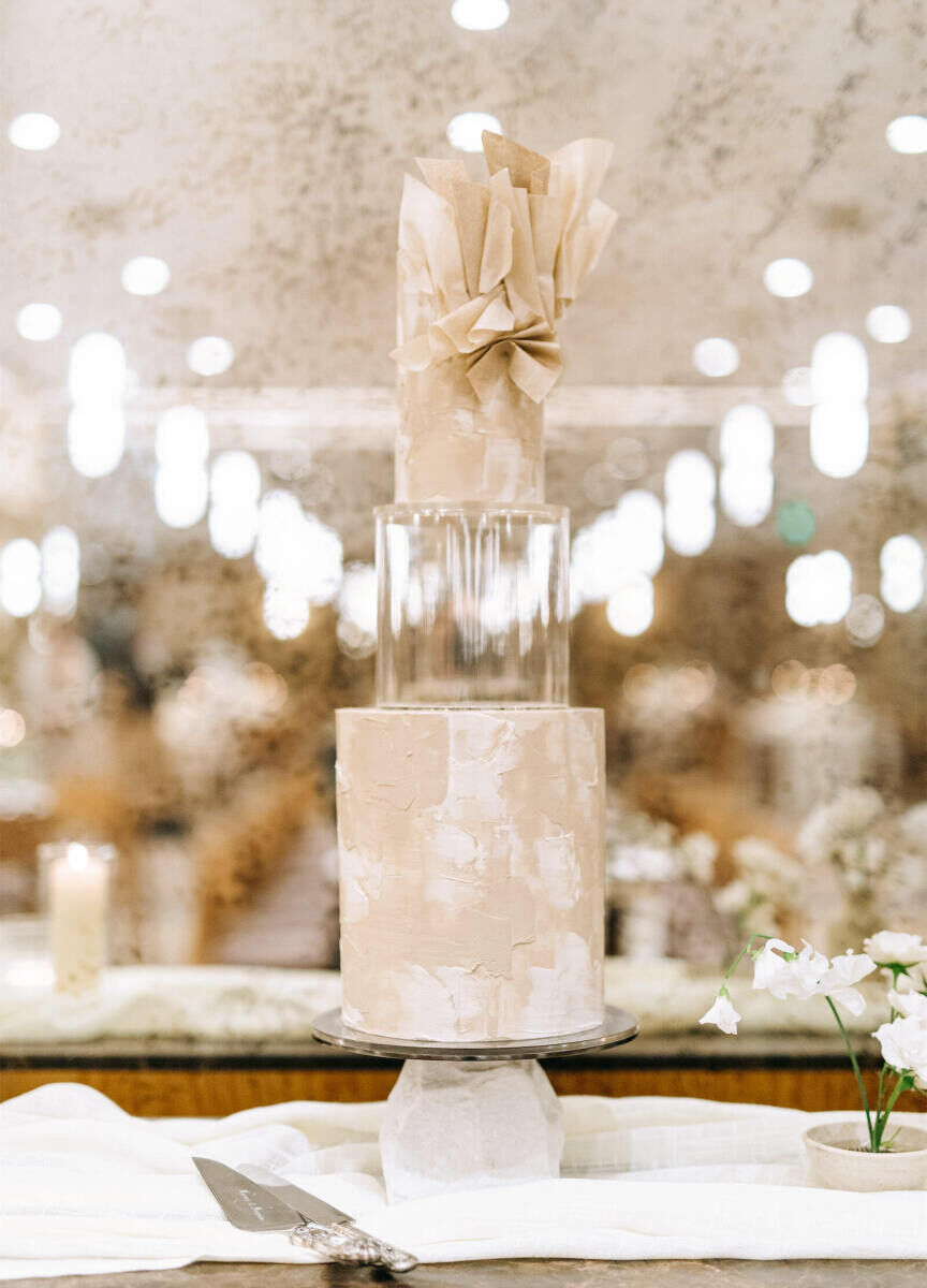 At a modern California wedding, two tiers of wedding cake were separated by a clear, plastic spacer, giving it a unique look.