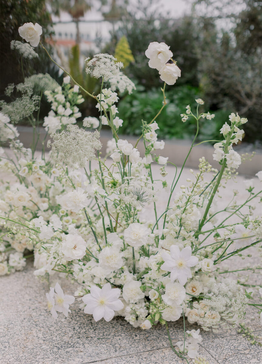 Low, all-white floral arrangements decorated the ceremony at a modern California wedding in Santa Monica.