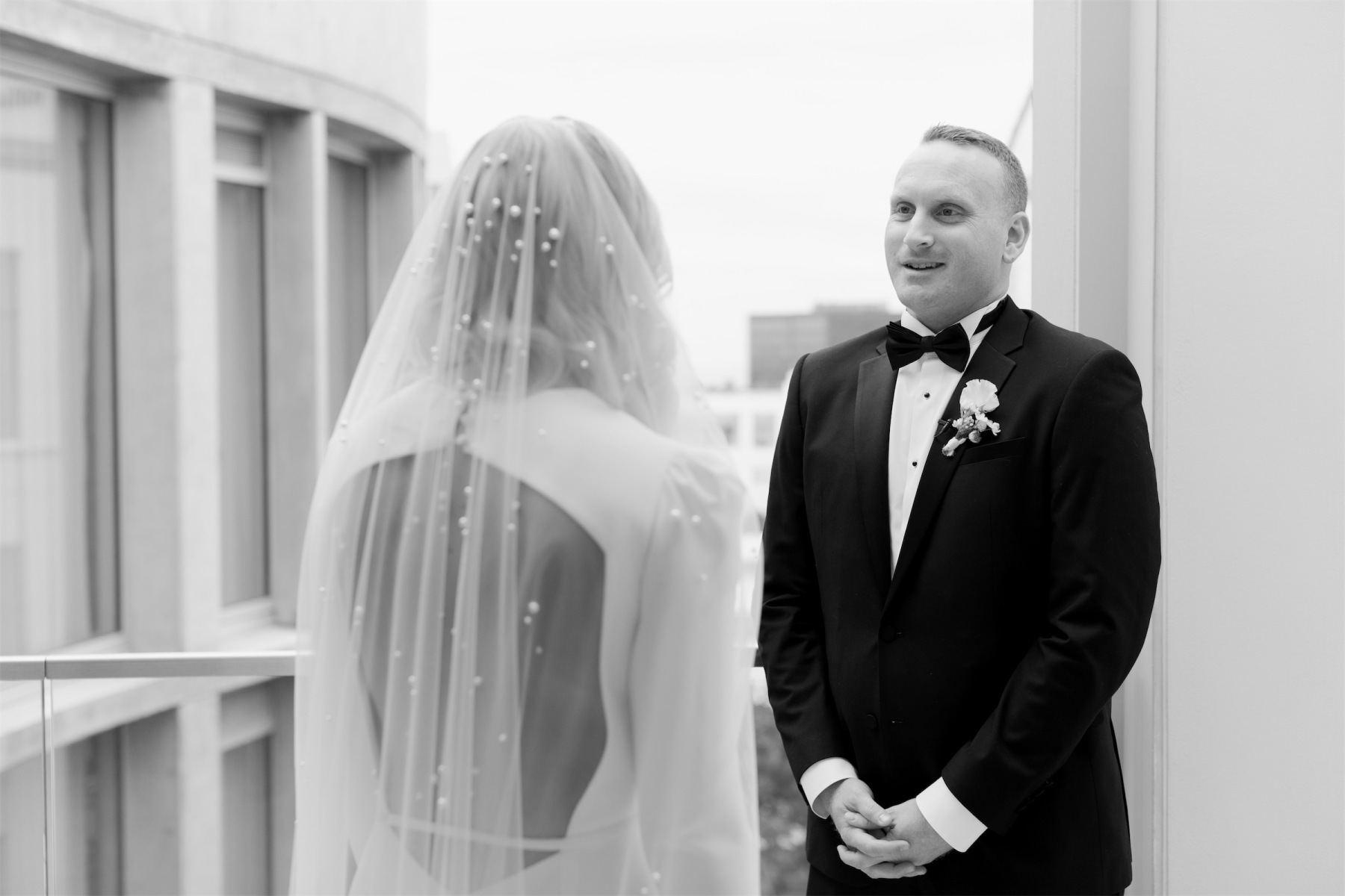 A bride and groom share an emotional first look before their modern California wedding ceremony.