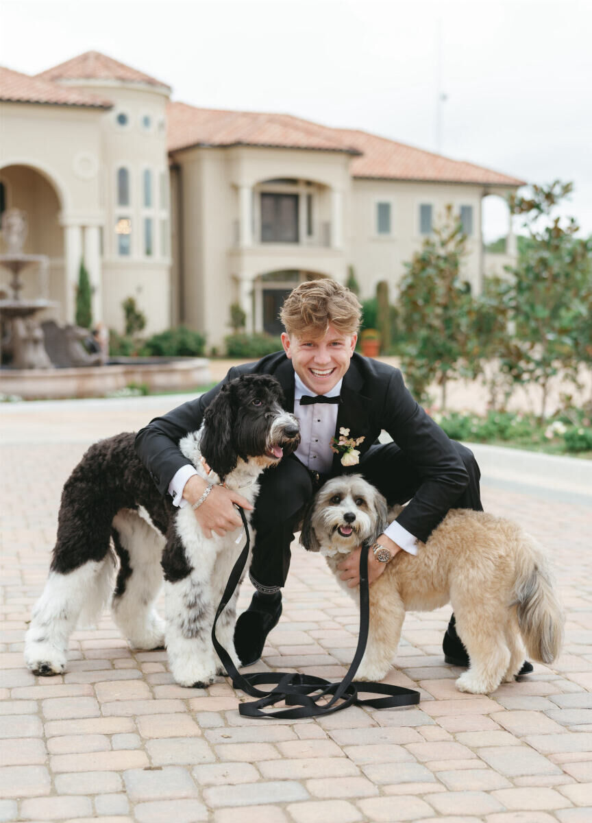 A groom and his two dogs take a photo together during his modern fairytale wedding in Texas.
