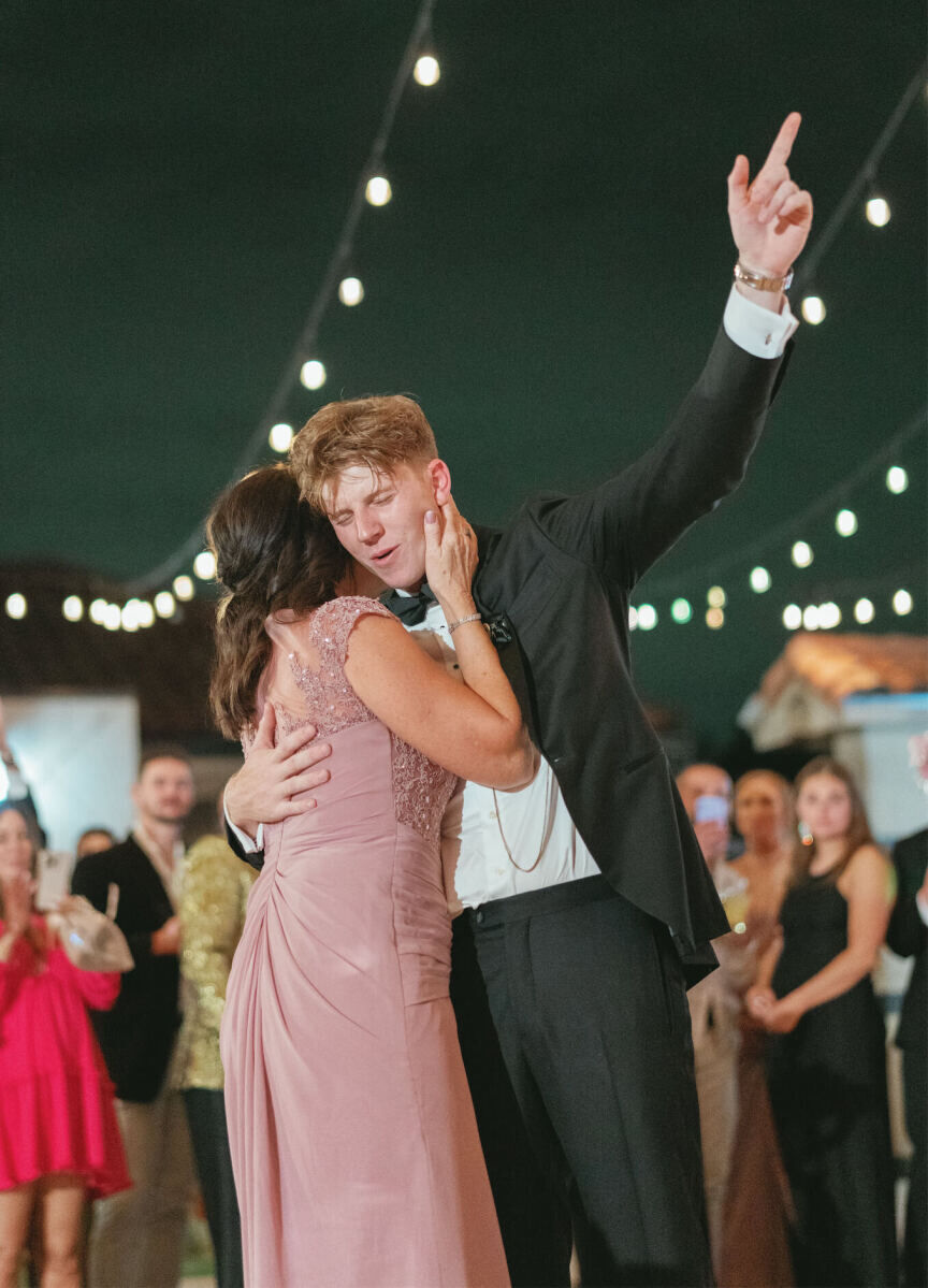 A groom and his mother share a dance during a modern fairytale wedding reception in Texas.
