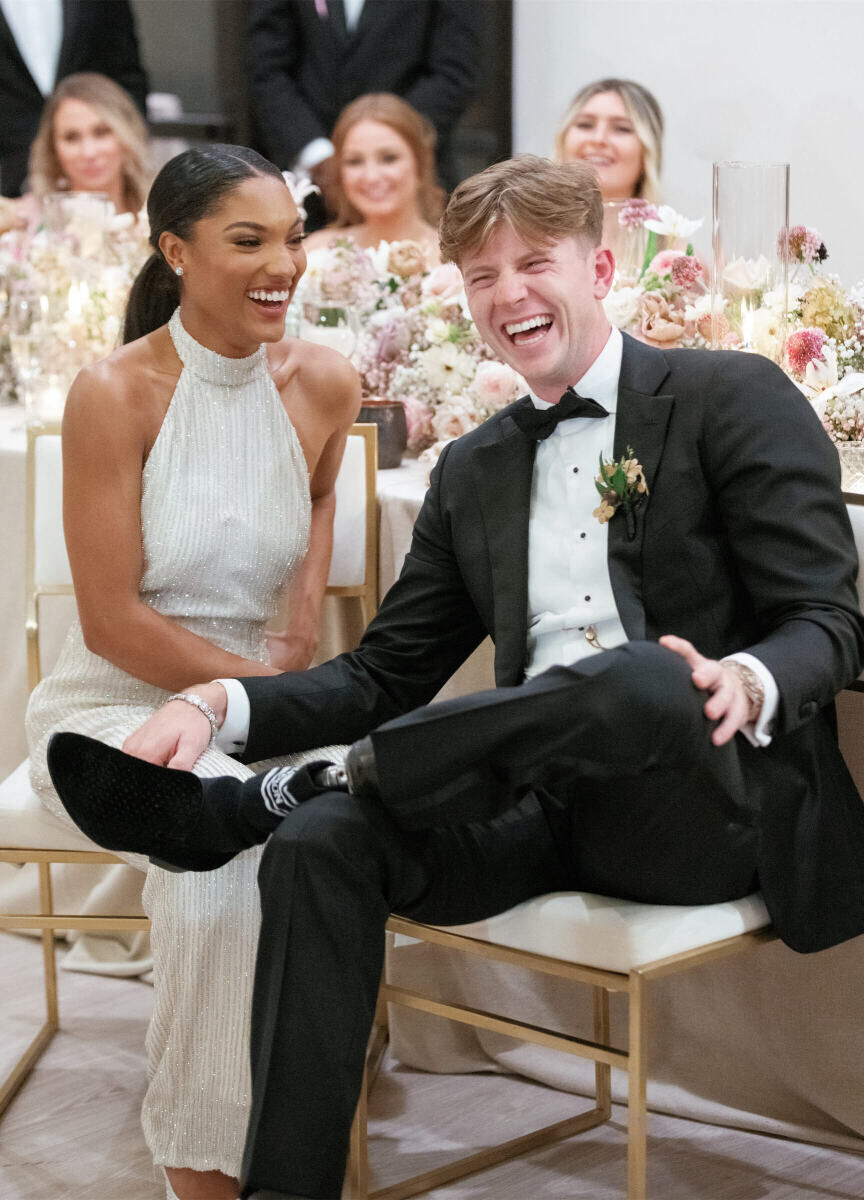 The bride and groom share a laugh during their modern fairytale wedding reception.