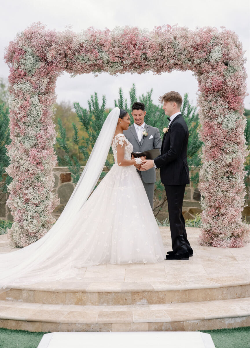 Tara Davis and Hunter Woodhall exchange vows during their modern fairytale wedding ceremony in Texas.