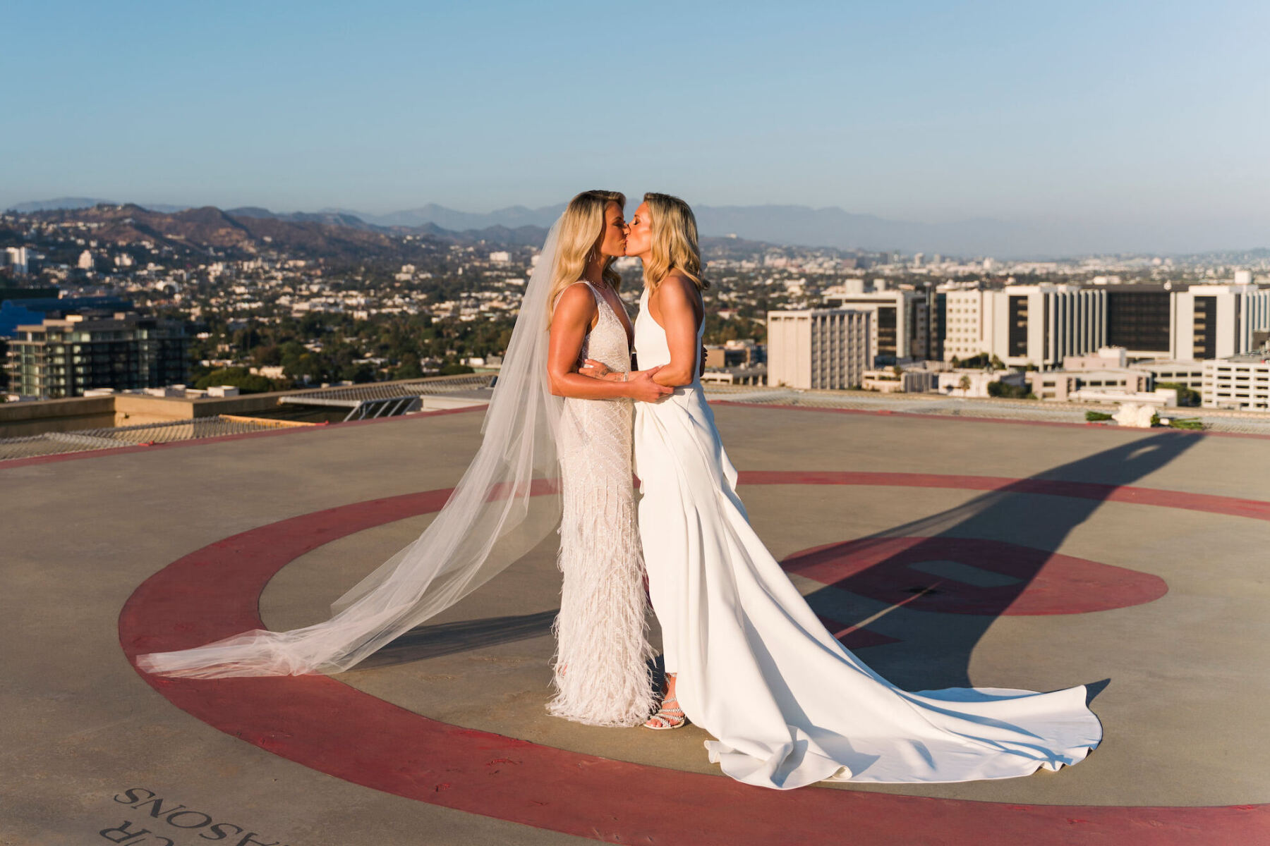 Following their ceremony, these brides took portraits on the helipad of their Los Angeles wedding venue.