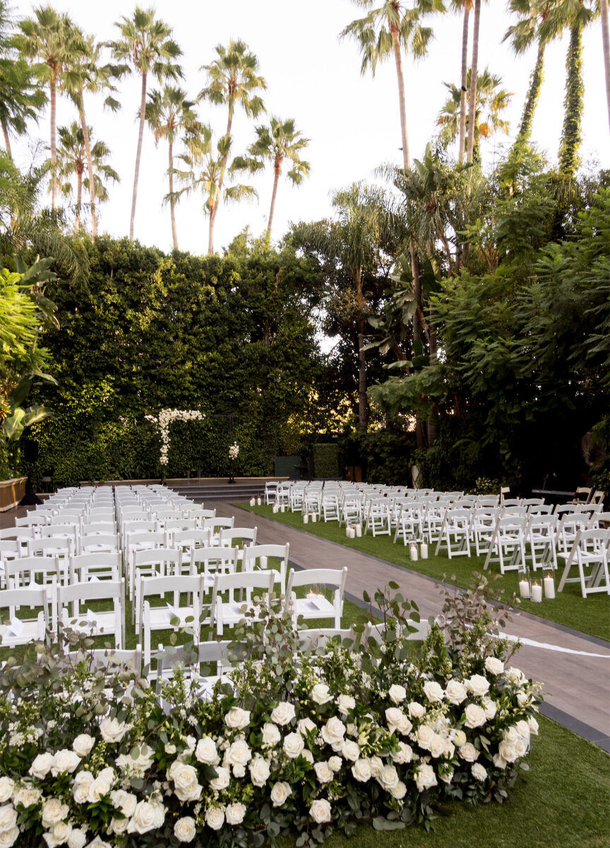 A modern garden wedding ceremony, with white roses anchoring the space.
