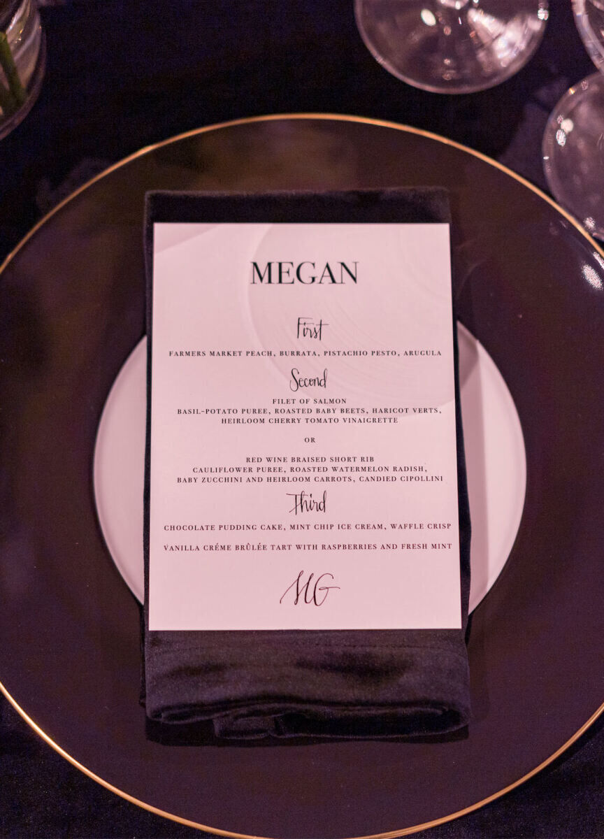 A dinner menu for a modern wedding outlined the meal using a serif font and spot calligraphy.
