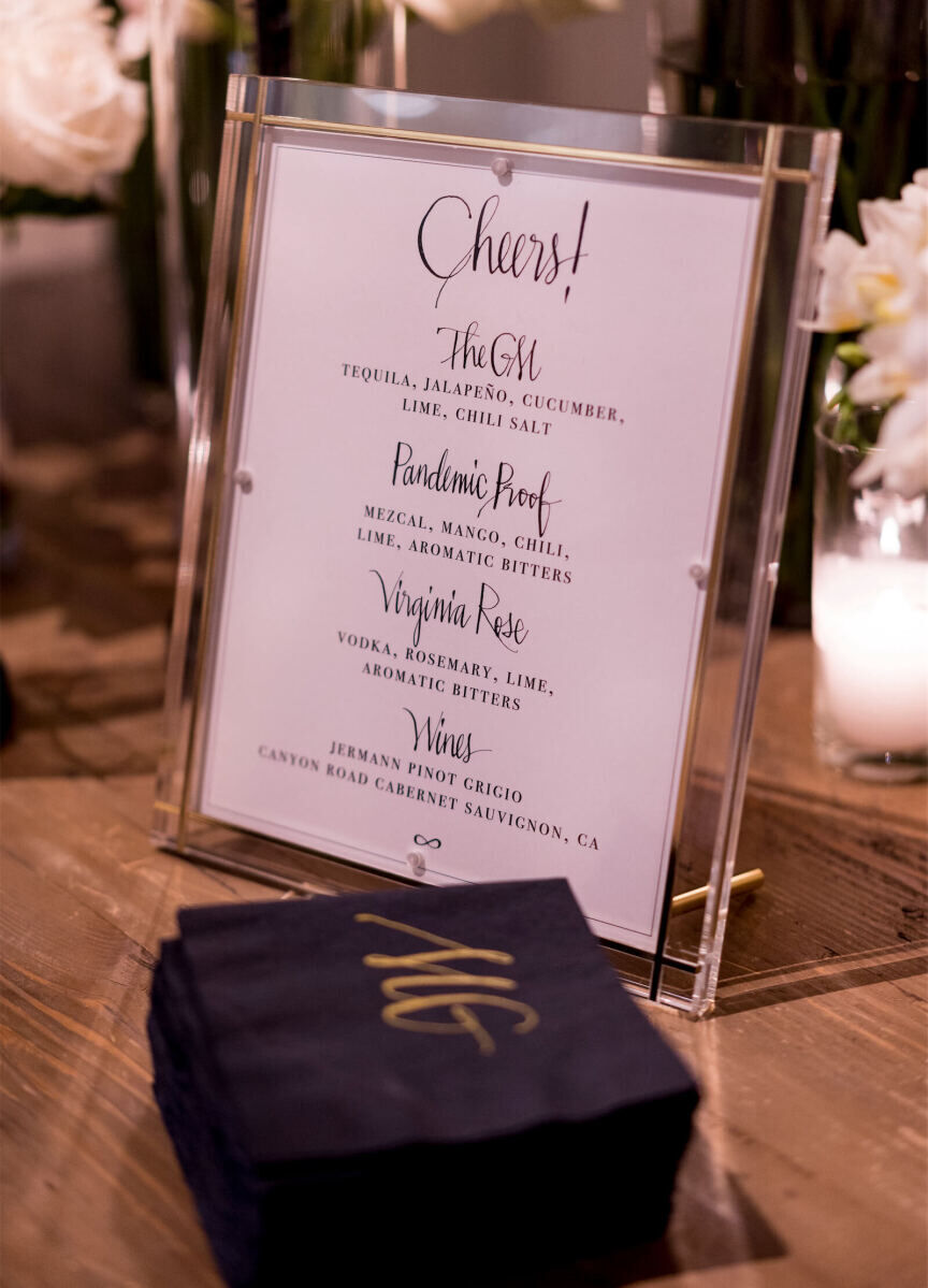 The bar menu and cocktail napkins at a modern wedding reception showcased the celebration's signature calligraphy.