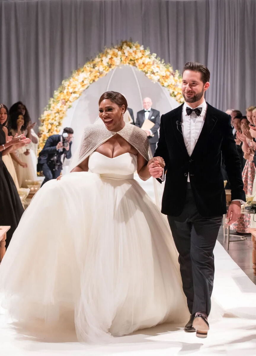 Most Influential Women in History Weddings: Serena Willams just married moment, as she walks down the aisle with husband Alexis Ohanian in her stunning white wedding ball gown and cape.