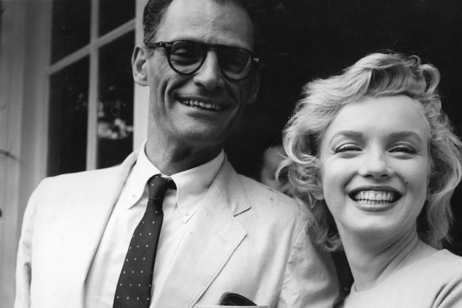 Most Influential Women in History Weddings: Marilyn Monroe posing arm in arm with husband Arthur Miller