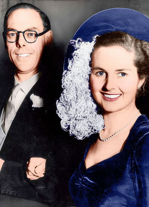 Most Influential Women in History Weddings: Prime Minister Margaret Thatcher in a blue hat and suit posing with husband Dennis Thatcher