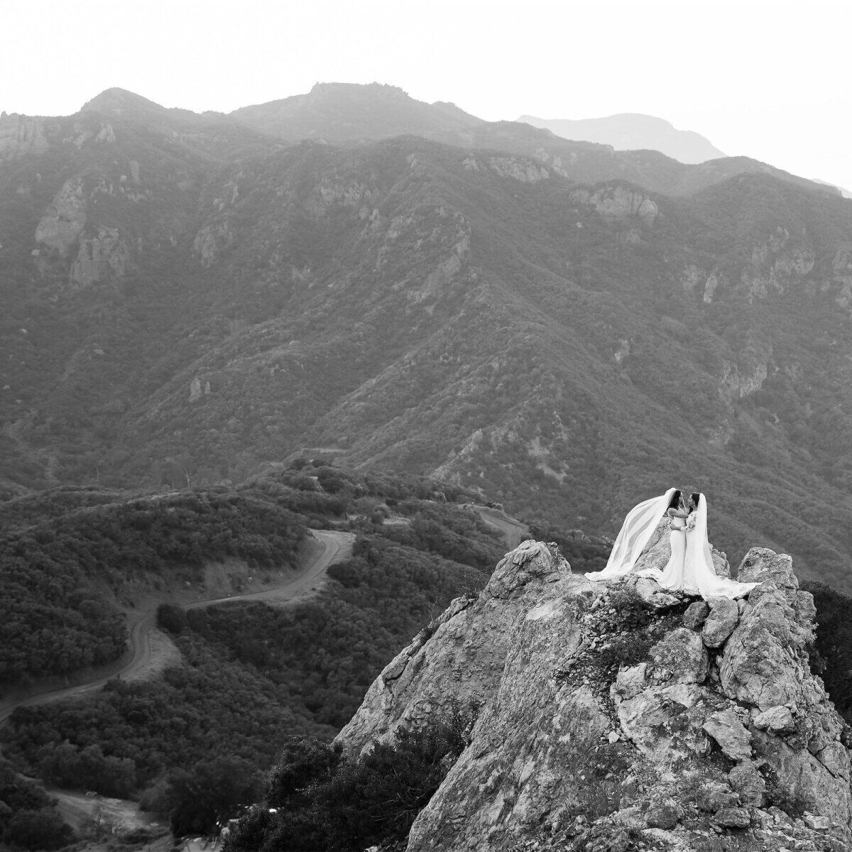 Mountain Wedding: Two brides embracing on a mountain in Malibu, California.