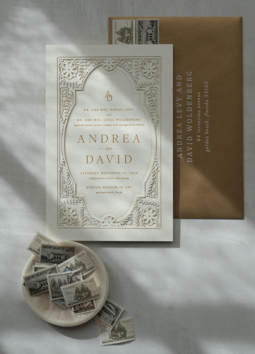 A laser-cut, gold-and-white wedding invitation.