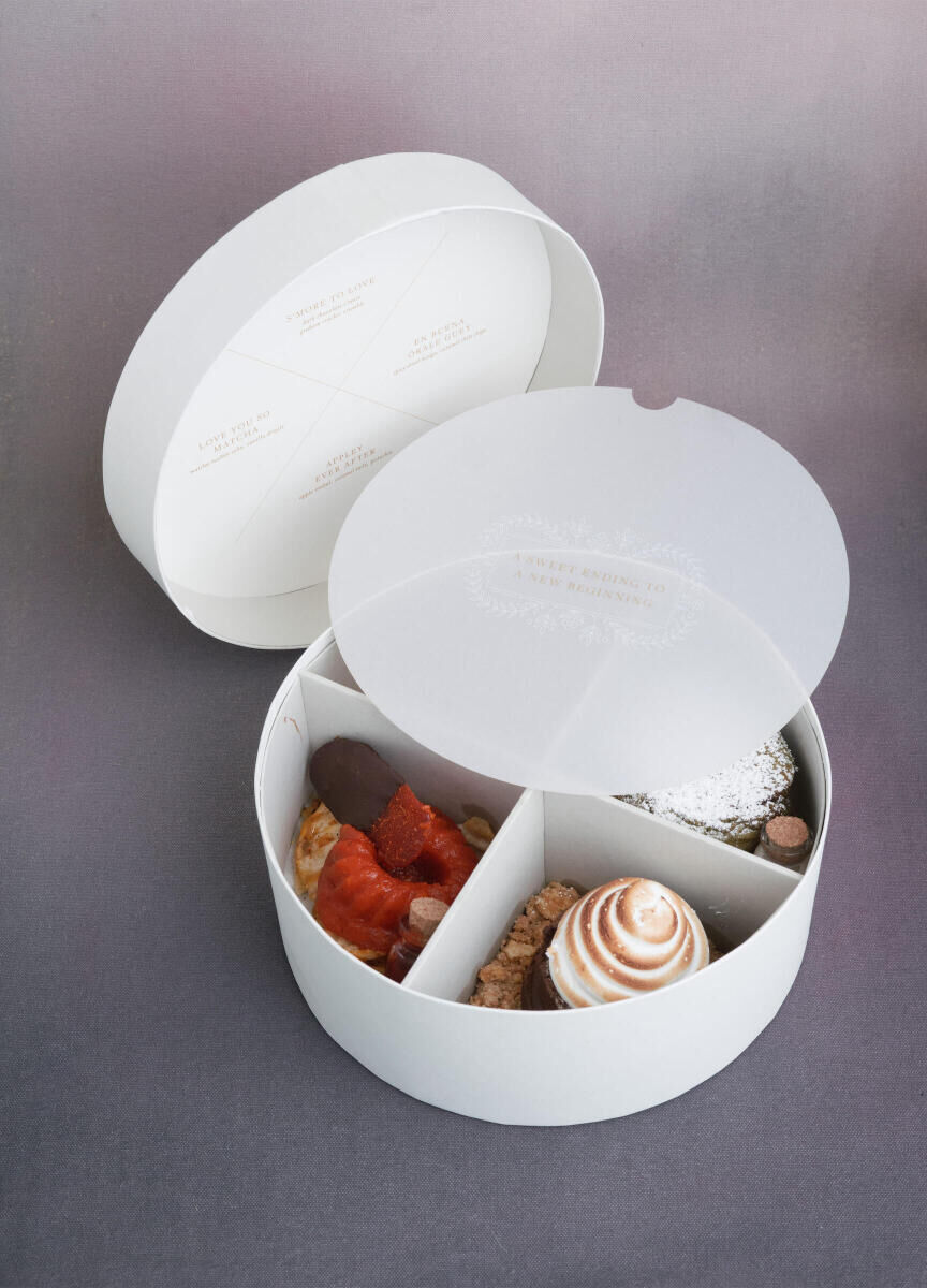 A round box with four different desserts inside was designed as a unique way for guests to have their own mini buffet of sweets.