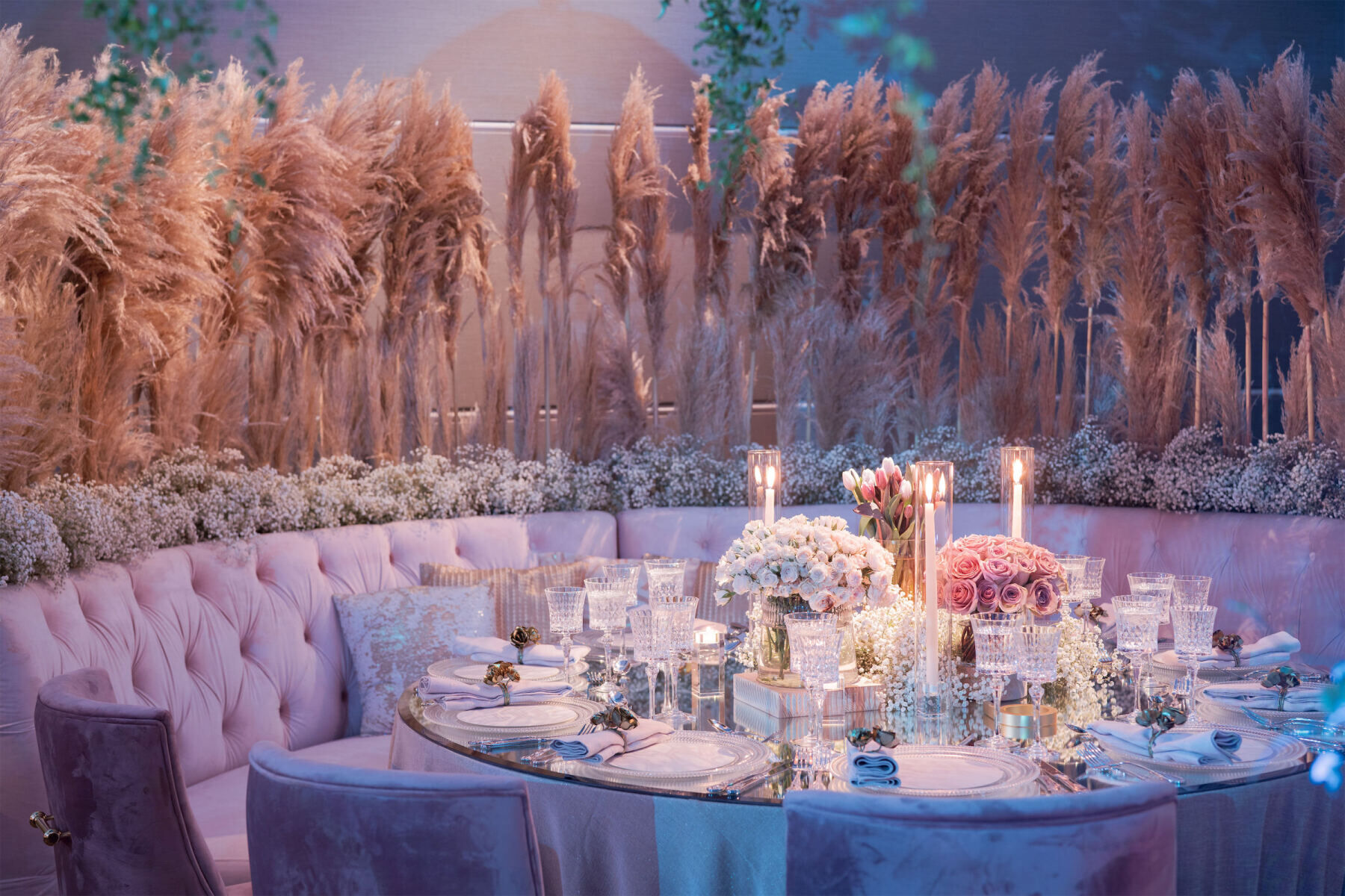 Pampas grass surrounds a tufted banquet and round table at this indoor, museum wedding reception inspired in part by North Carolina.