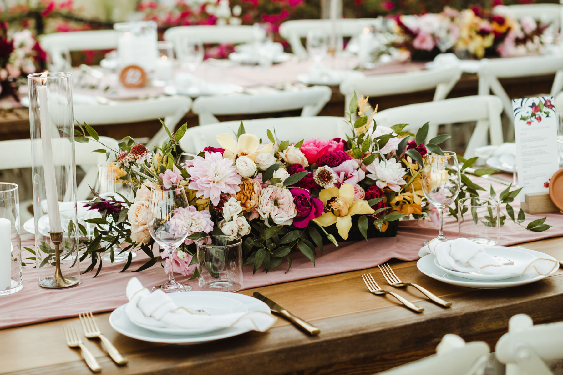 Pink Wedding: A brightly colored floral arrangement on a reception table.