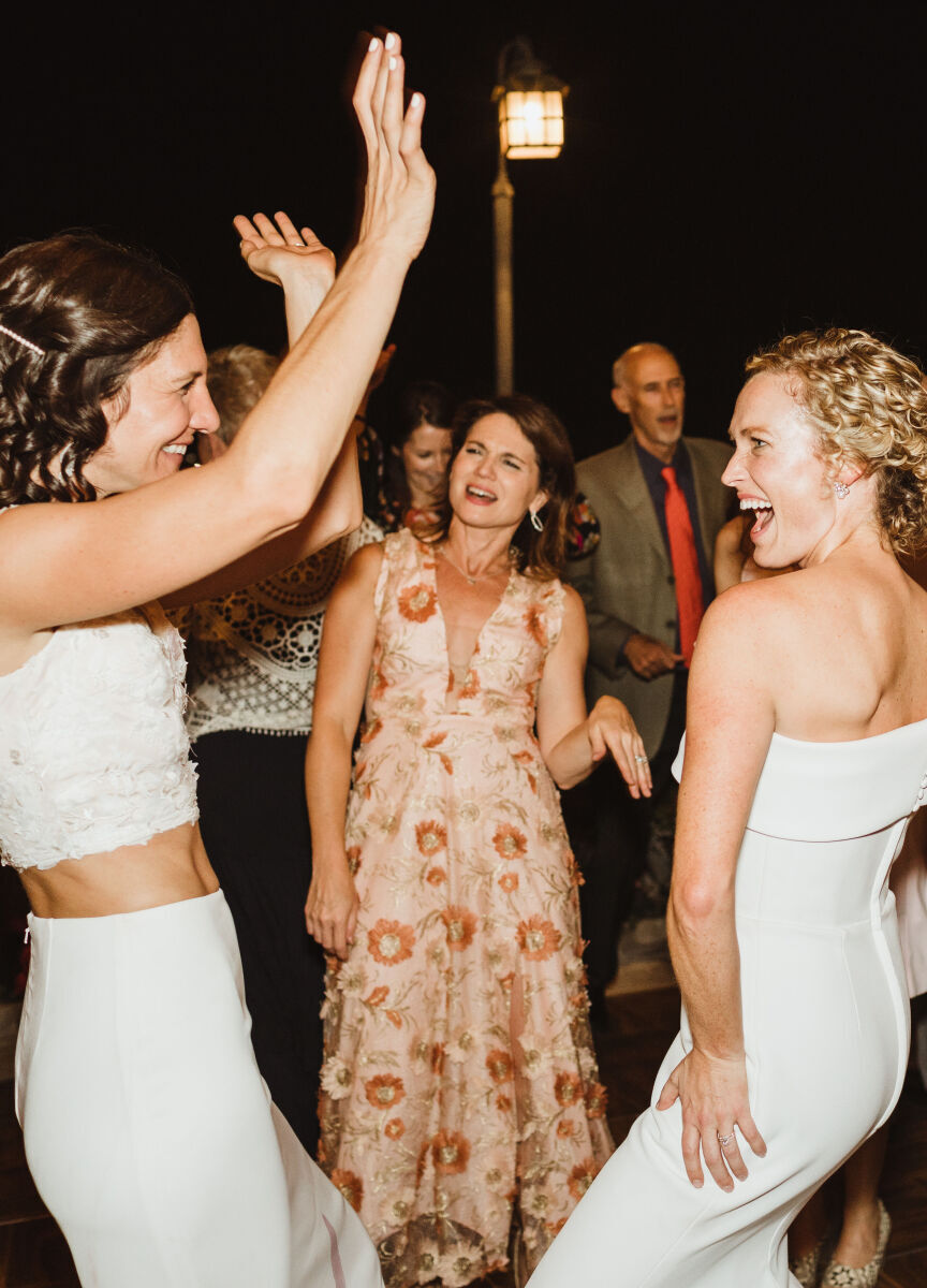 Pink Wedding: Two brides dancing on the dance floor at their wedding reception.