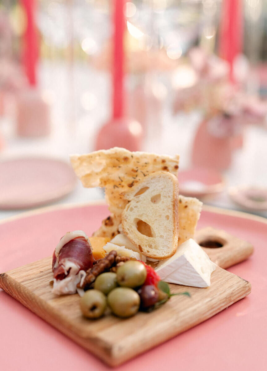 Individual cheese and charcuterie boards kicked off the dinner reception at a rainbow wedding.