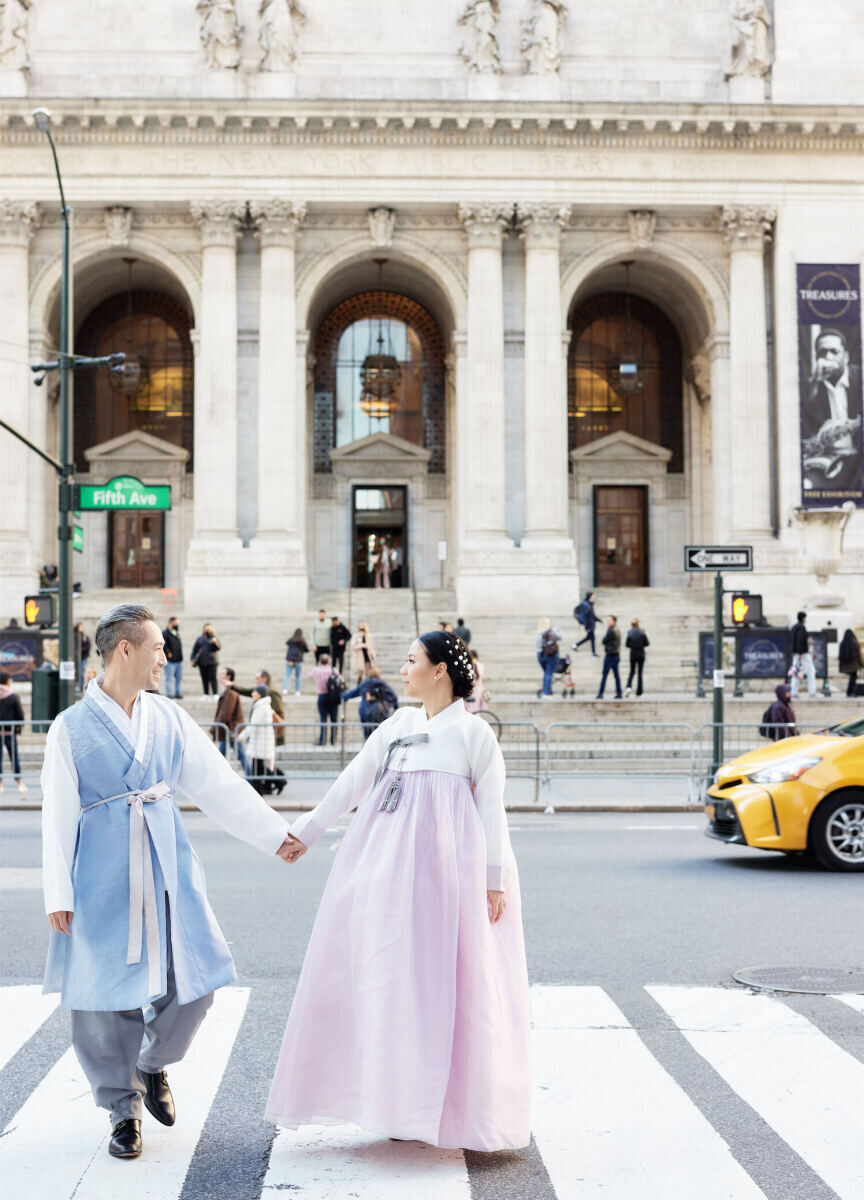 Prior to changing into a tuxedo and wedding dress for their restaurant wedding reception, this groom and bride roamed iconic New York City settings like the New York Public Library in their traditional hanboks.
