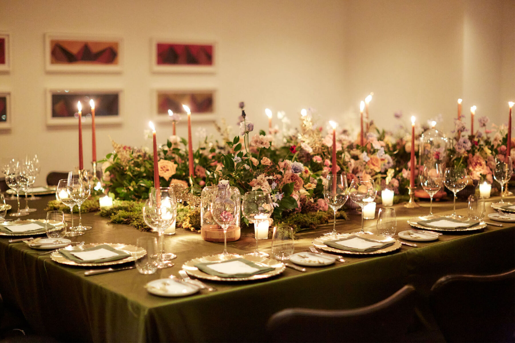 For this restaurant wedding, one long table held all the guests and was decorated with candles, moss, fresh flowers, and fresh fruit.