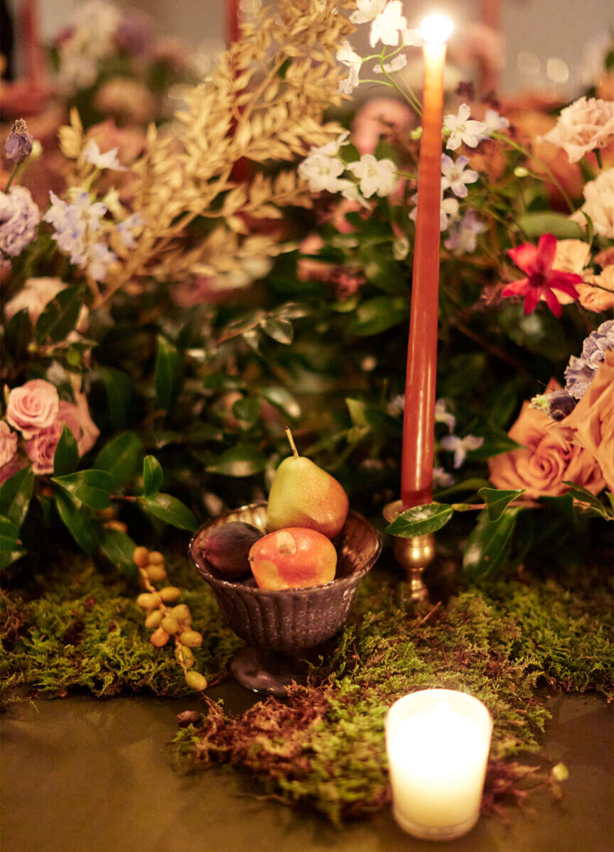 The centerpieces of a restaurant wedding incorporated fruit like figs and ornamental pears.