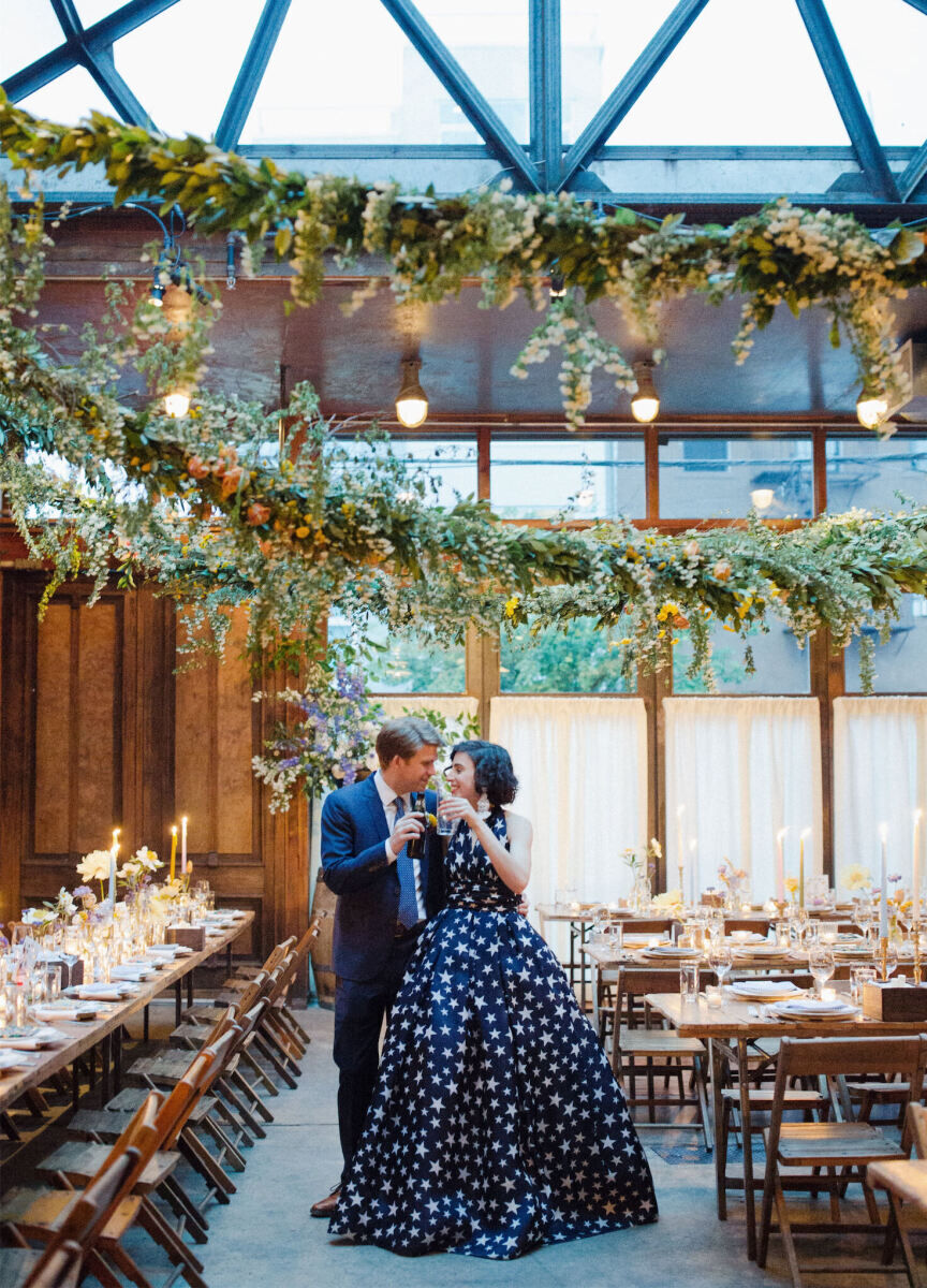 Restaurant Weddings: A bride and groom cheers-ing drinks in Brooklyn Winery.