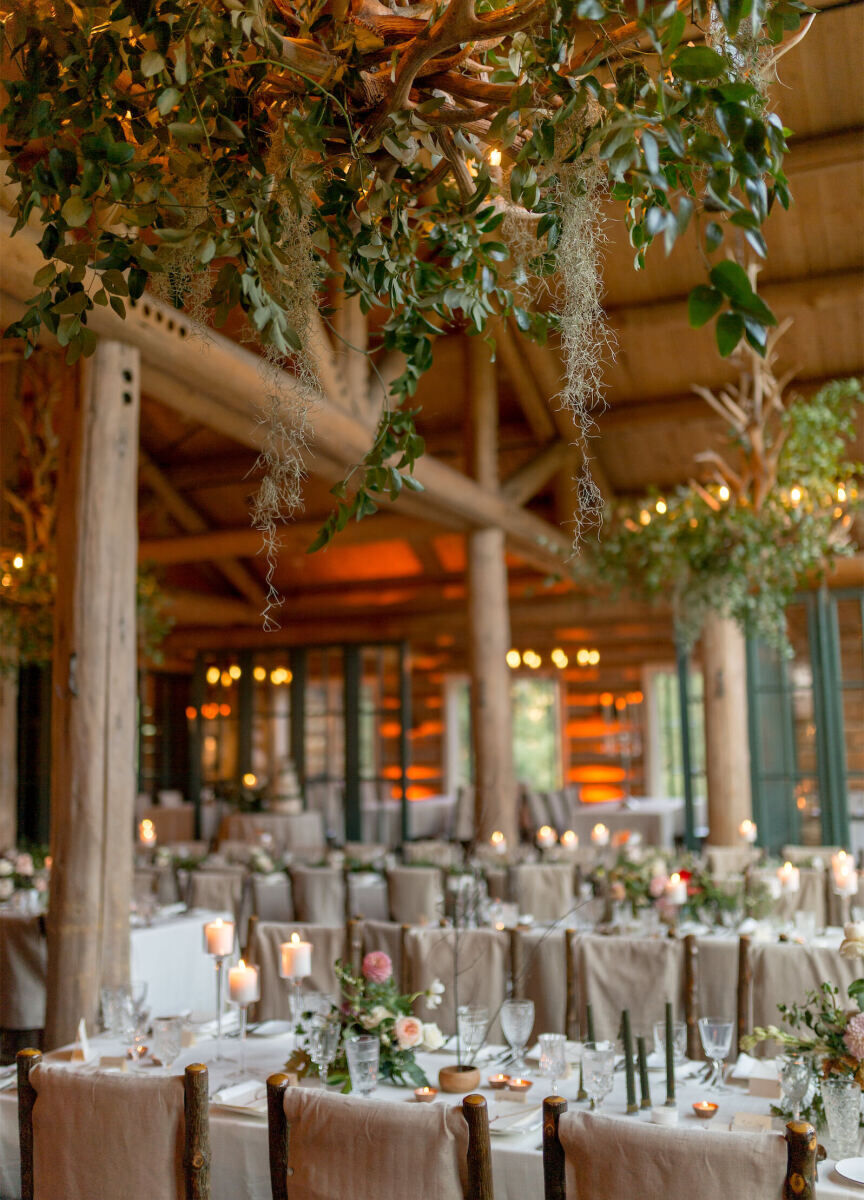 Restaurant Weddings: A dreamy reception set-up at Beano's Cabin with greenery hanging down from the wooden beams.