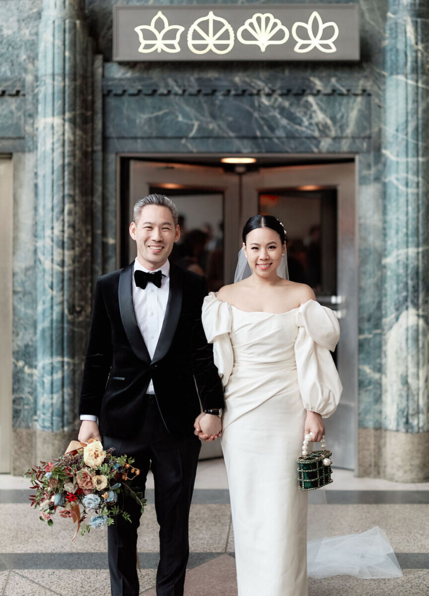 Restaurant Weddings: A bride and groom smiling and holding hands while standing in front of Eleven Madison Park.