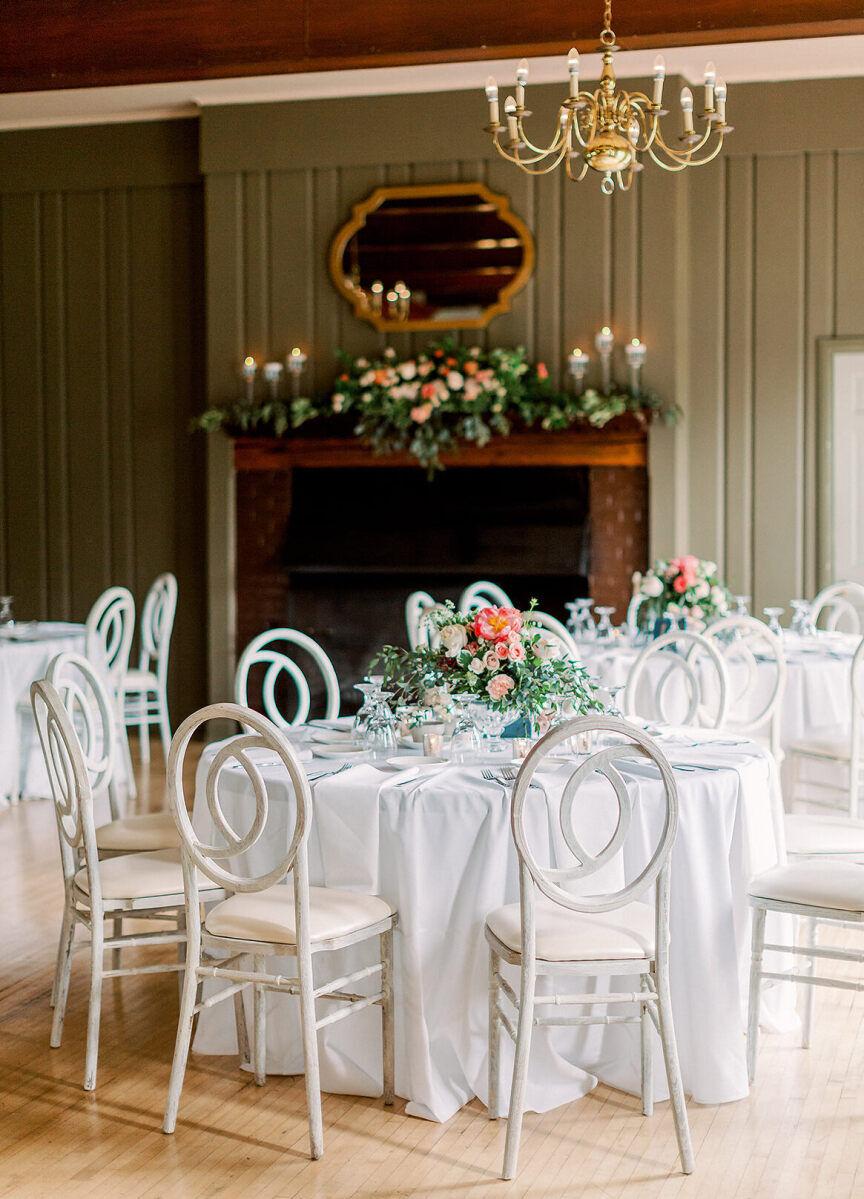 Restaurant Weddings: A white reception table set up in front of a fireplace.