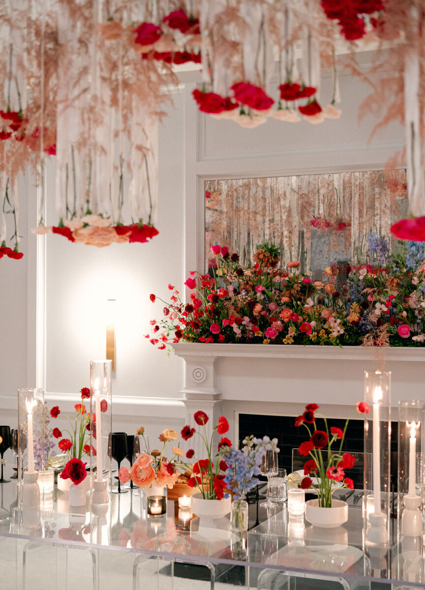 Romantic Wedding Venues: Pink and red florals decorating the ceiling, mantle, and reception tables at The Line DC.
