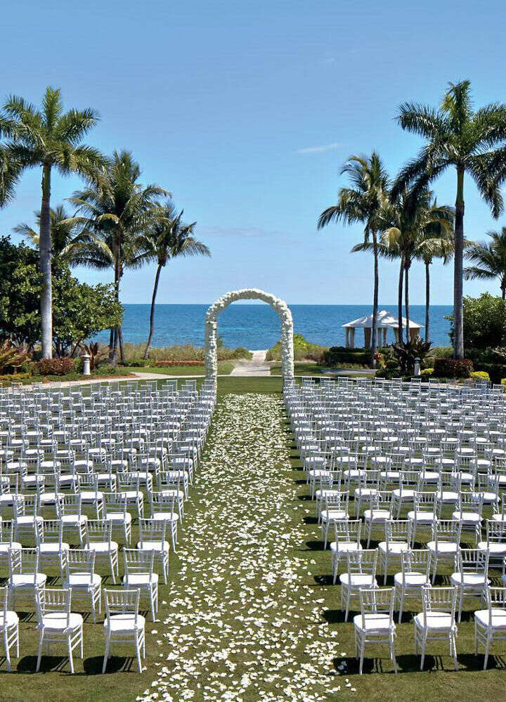 Romantic Wedding Venues: A large outdoor wedding ceremony setup at The Ritz-Carlton Key Biscayne, Miami.
