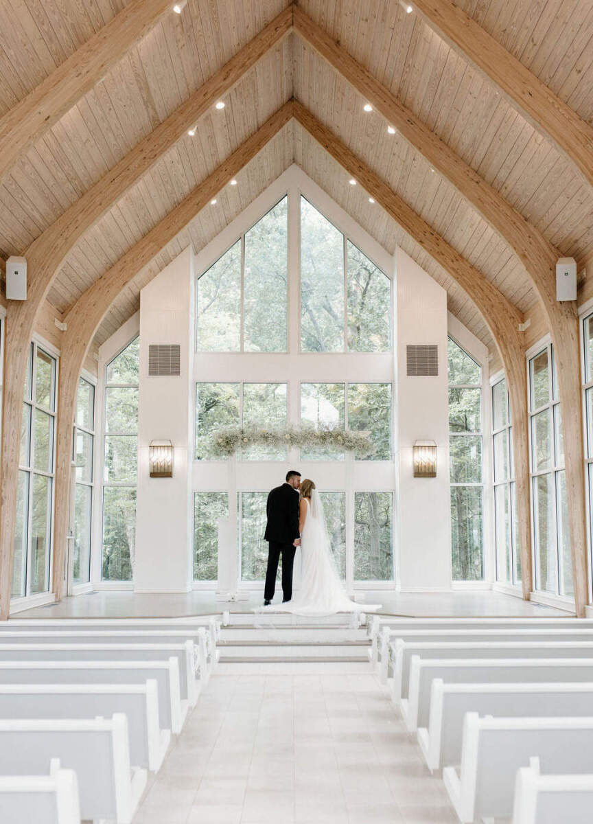 Romantic Wedding Venues: A bride and groom arm-in-arm at Glass Chapel.
