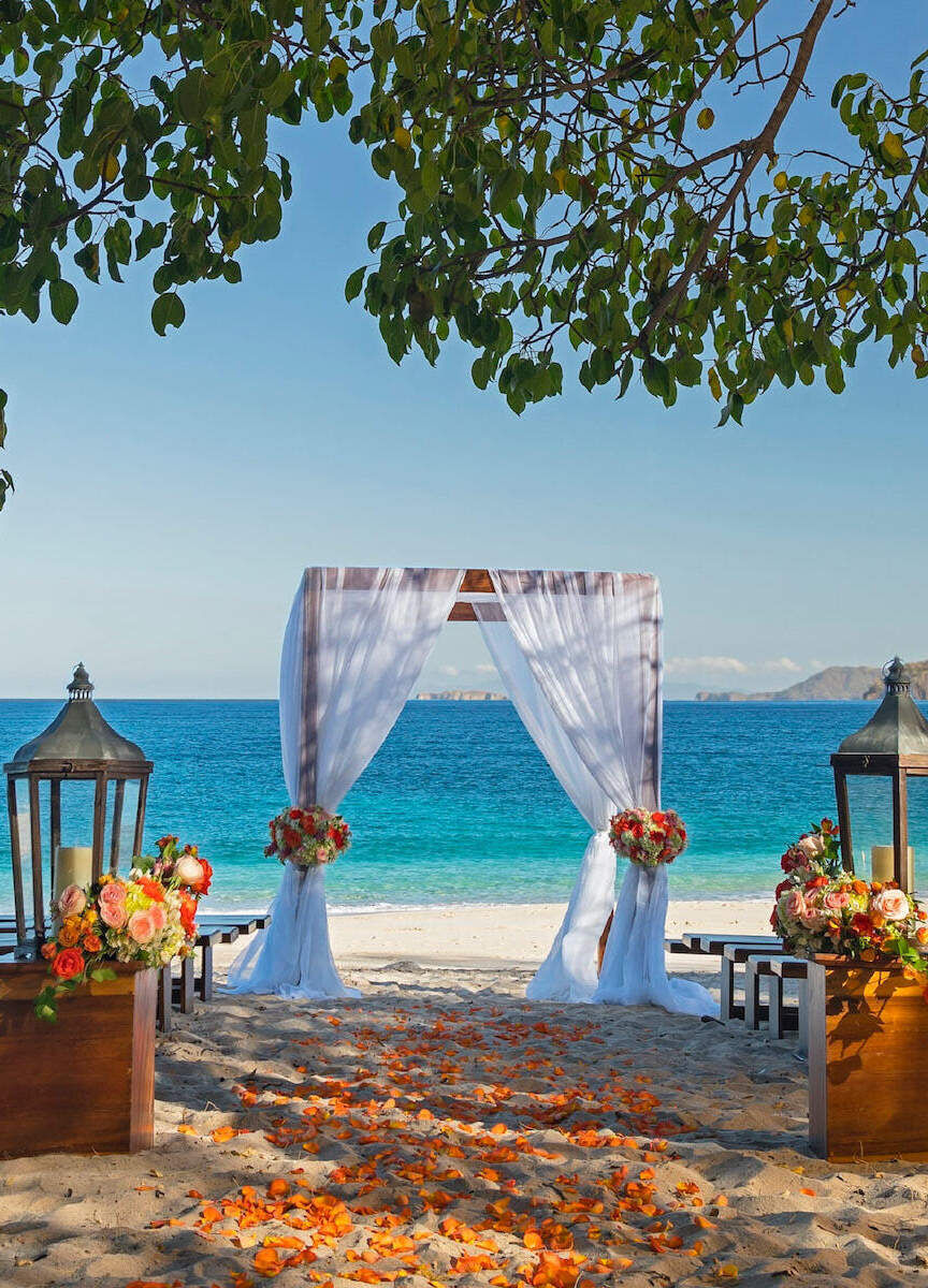 Romantic Wedding Venues: A beach ceremony setup at The Westin Reserva Conchal, an All-Inclusive Golf Resort & Spa.