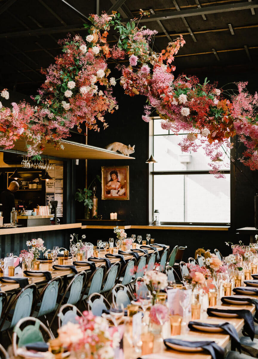 Romantic Wedding Venues: Rupert on Rupert decorated in pink, white, and red florals hanging from the ceiling and sitting on the reception tables.