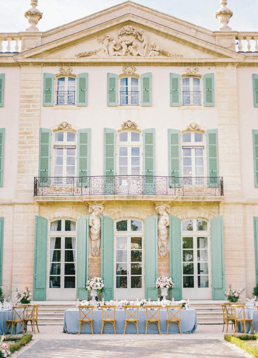 Romantic Wedding Venues: The outside of Chateau De Tourreau with an outdoor reception setup on a sunny day.