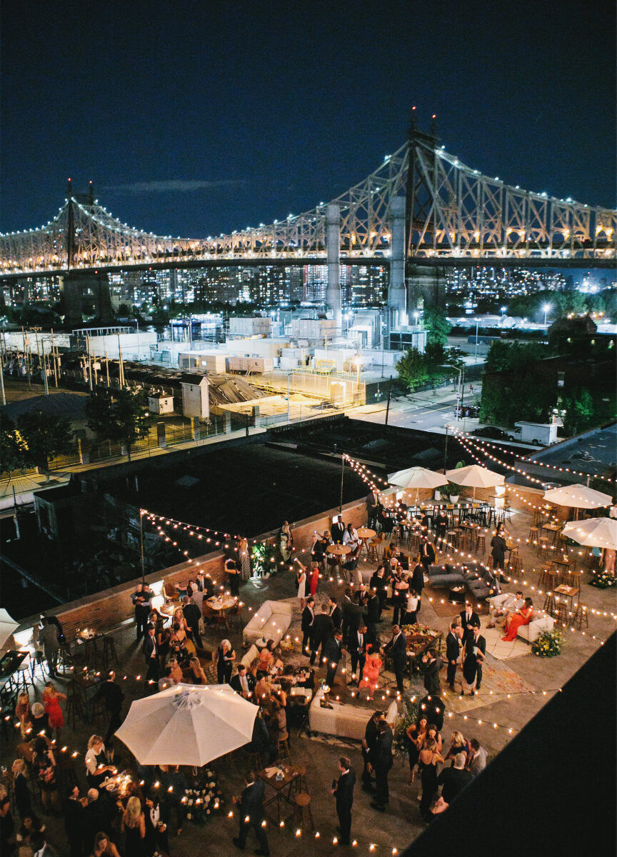SEO for Wedding Venues: An outdoor cocktail hour in the evening with views of the Queensboro Bridge in the background.