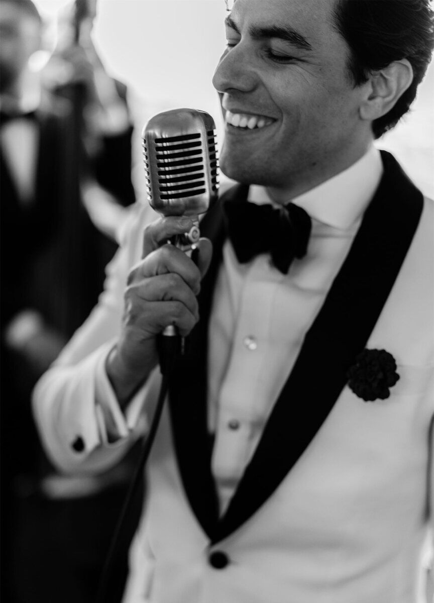 A jazz crooner sings into an old-school microphone at a surprise wedding in DC.