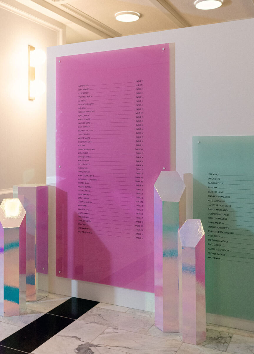 An iridescent seating chart helped guests find their seats at the reception of a surprise wedding.