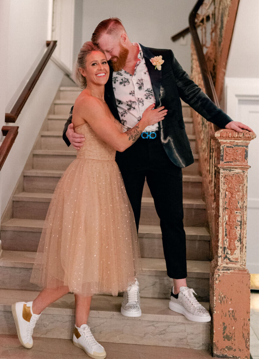 For the reception following their surprise wedding ceremony, the bride changed into a champagne-hued tea-length dress, the groom put on a floral shirt and statement blazer, and both slipped on bedazzled sneakers.