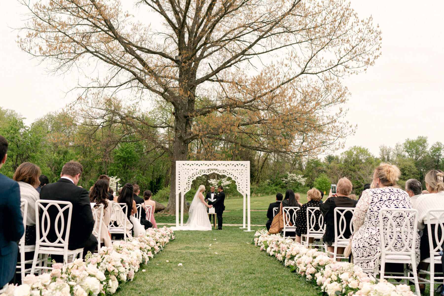 Tented Wedding: A couple standing at the alter of their outdoor wedding ceremony.