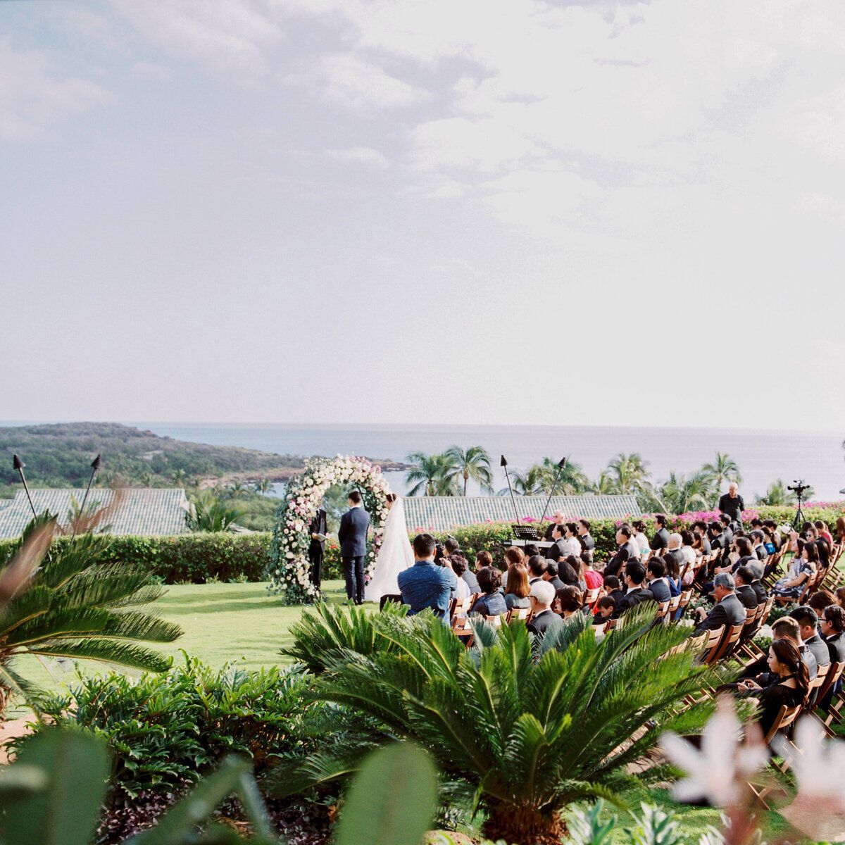 Wedding venue ideas: Scenic wedding venue Four Seasons Resort Lanai, ceremony overlooking the ocean and coast line 