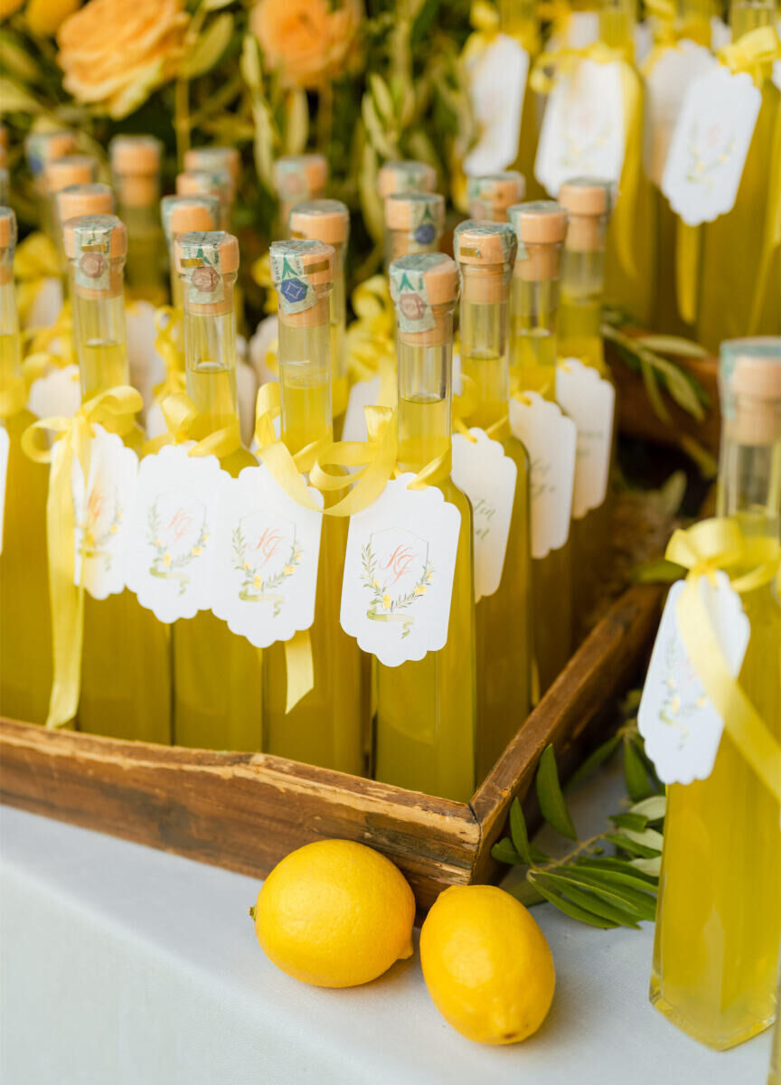 Limoncello bottles doubled as flavorful escort cards and favors at a Tuscan wedding.