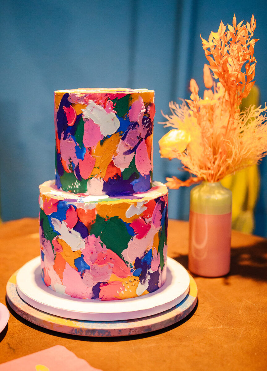 Inspired by the folk art meets pop art direction of this vibrant outdoor wedding, the cake maker created a colorful cake that looks freshly painted.