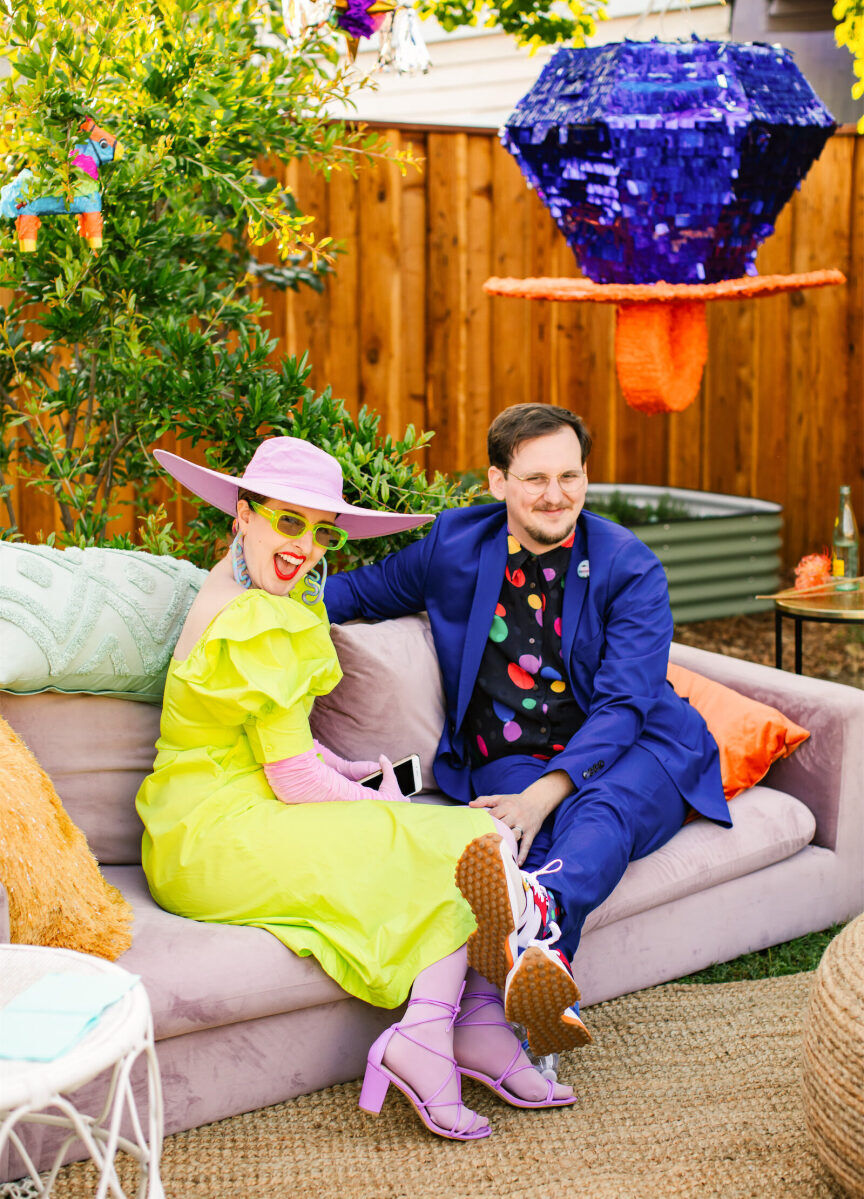 Guests enjoyed the mix of colorful rental furniture (accented by a ring pop piñata in honor of how the groom proposed) at this vibrant, outdoor wedding in Fresno, California.
