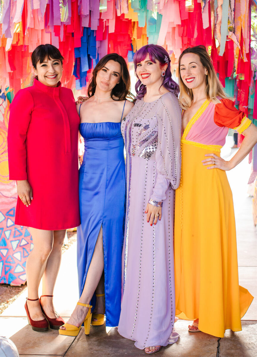 At her vibrant outdoor wedding, the bride wore a lilac gown, and asked guests to dressed colorfully too.