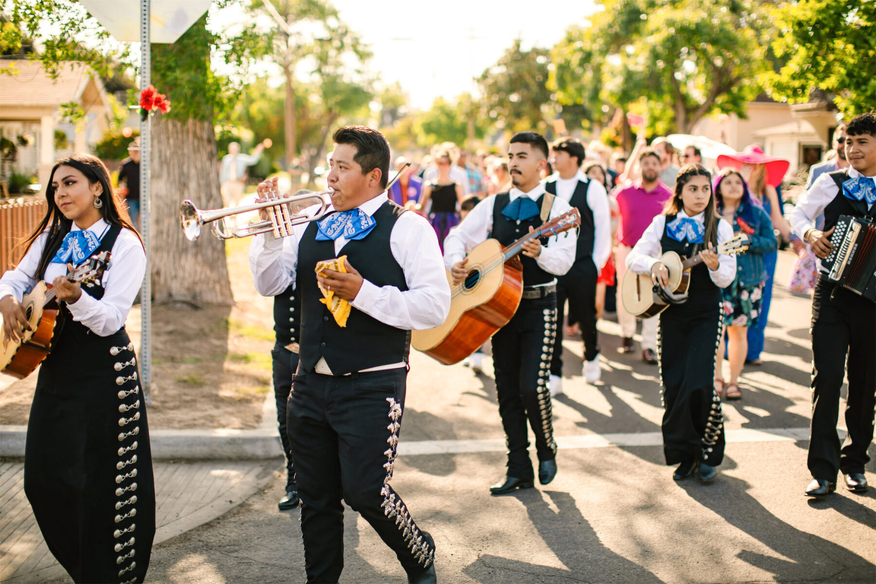 A mariachi band led guests on a parade between the ceremony and cocktail hour of a vibrant, outdoor wedding.