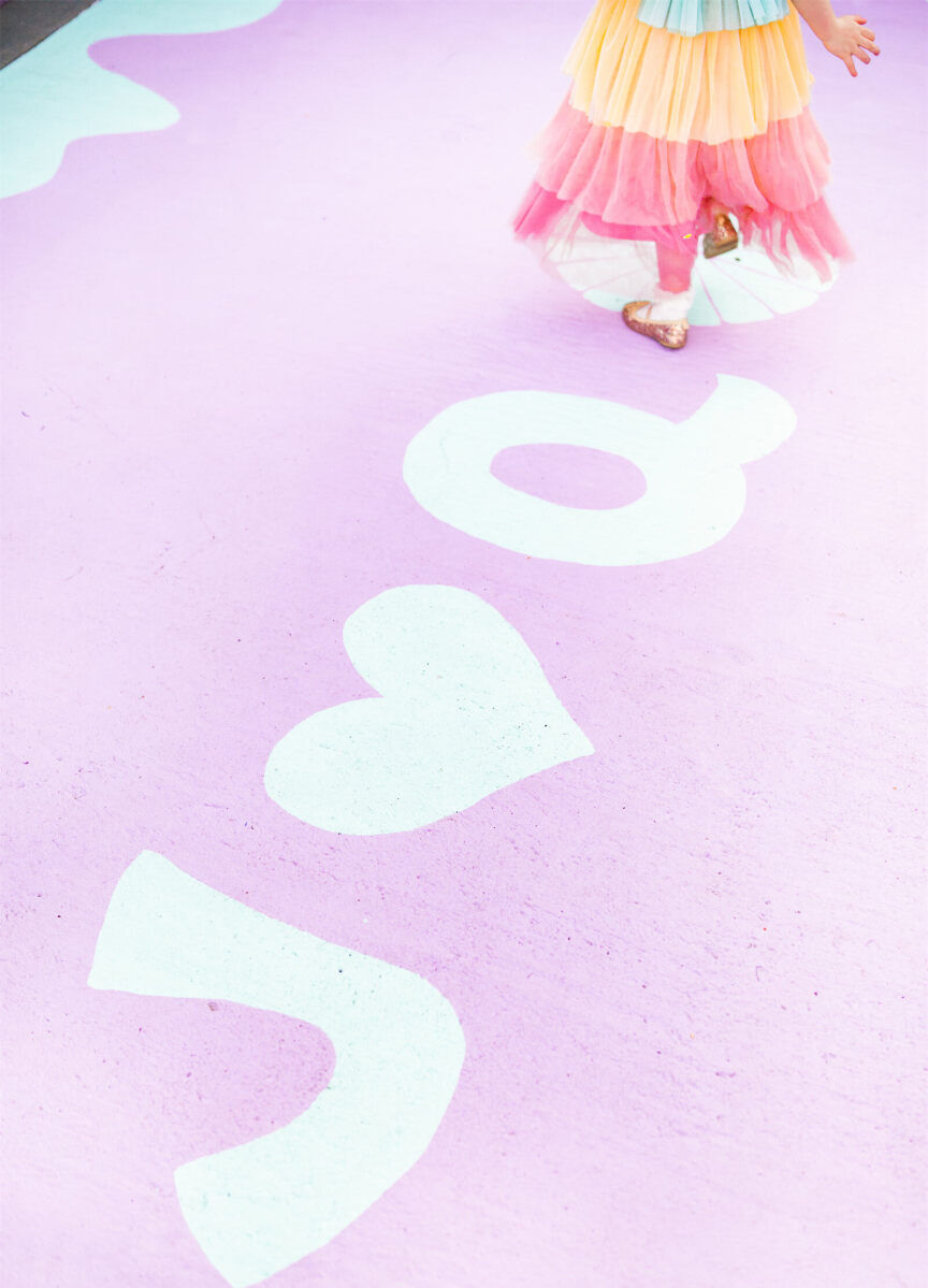 The bride painted the dance floor to anchor the vibrant, outdoor wedding reception space.