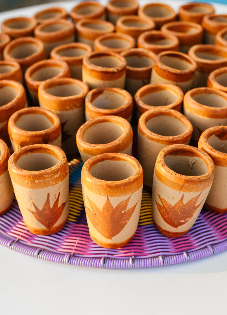 Mexican serving pieces, like these shot glasses, honored the groom's heritage but also doubled as keepsakes that the couple could continue to use long after their vibrant, outdoor wedding.