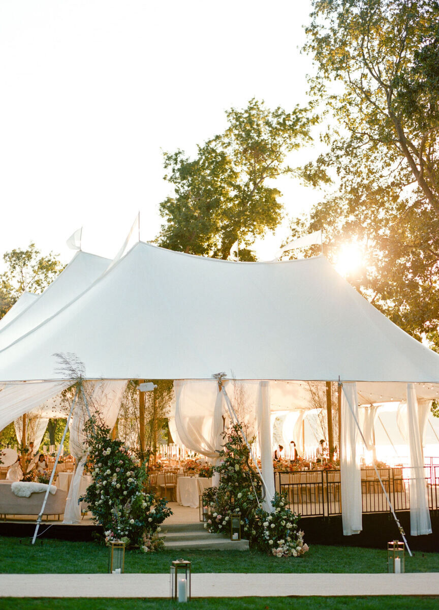 The reception tent at this waterfront wedding overlooked Oyster Bay and was decorated with flowers and greenery at the entrance.
