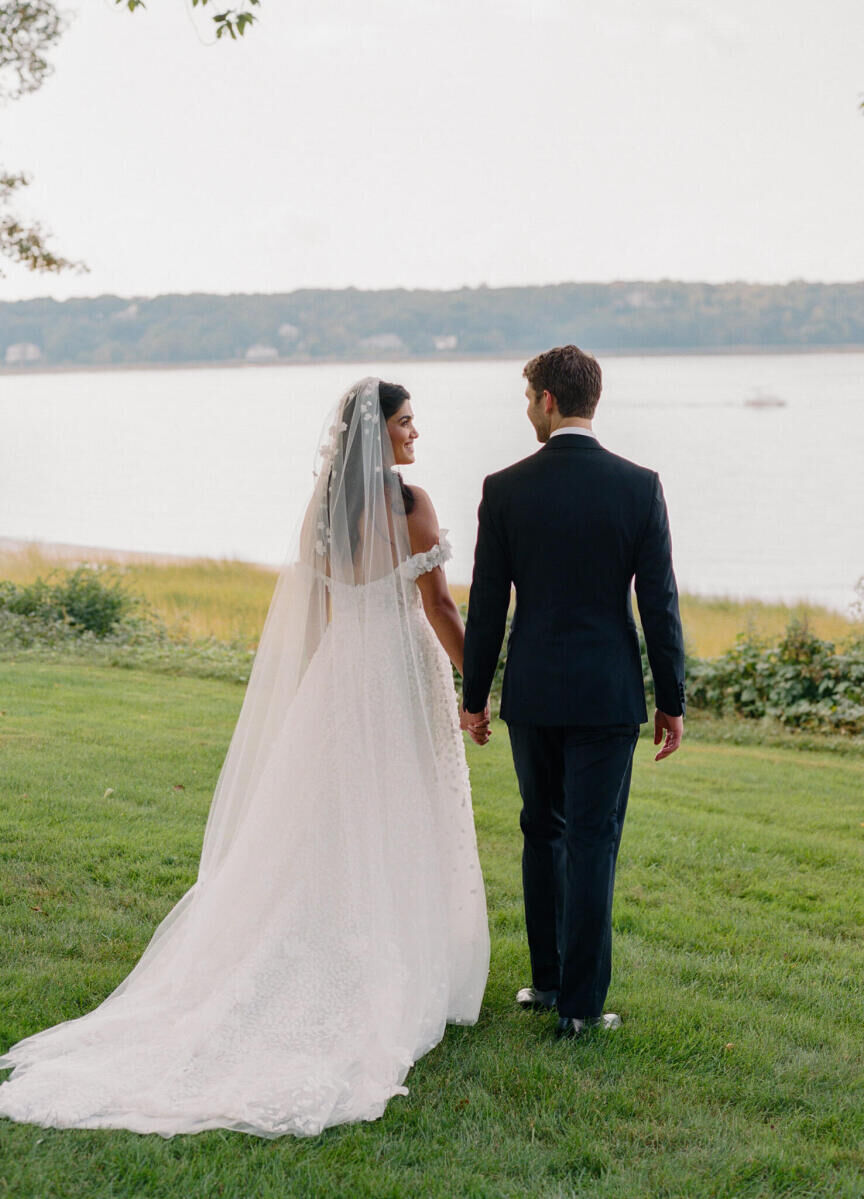 A bride and groom look into each other's eyes at their waterfront wedding in New York.